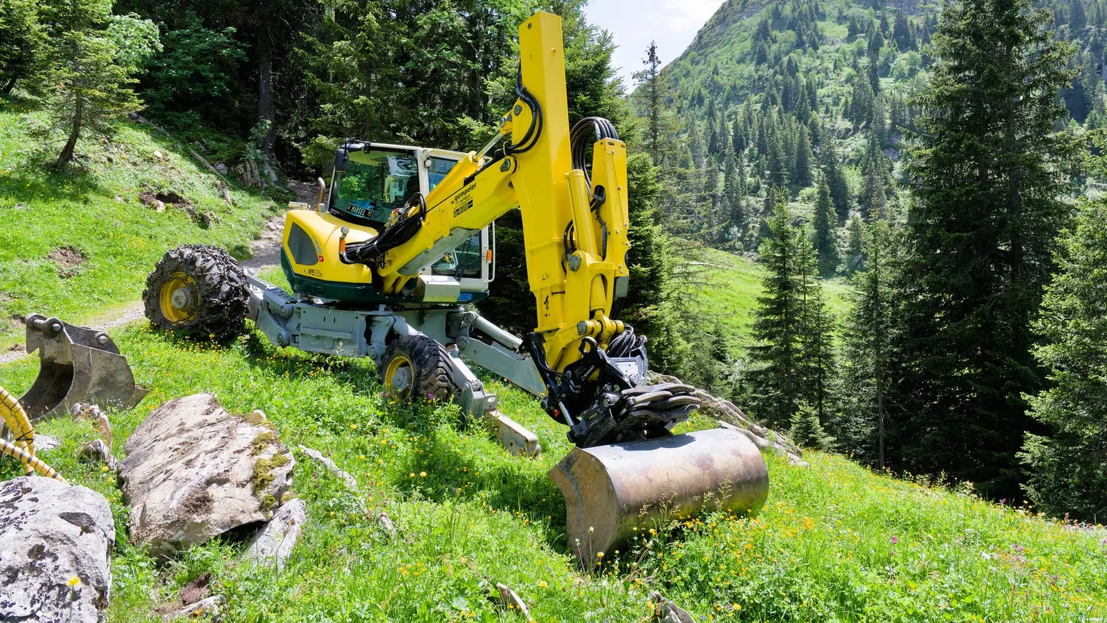 Compact track loader working with a bucket of soil on a residential property in metro Atlanta