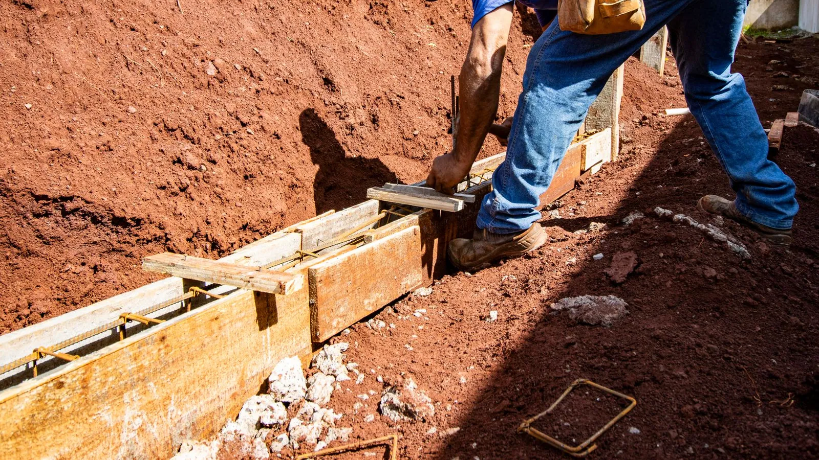 Broken concrete slab being removed and loaded for haul-off from a residential driveway